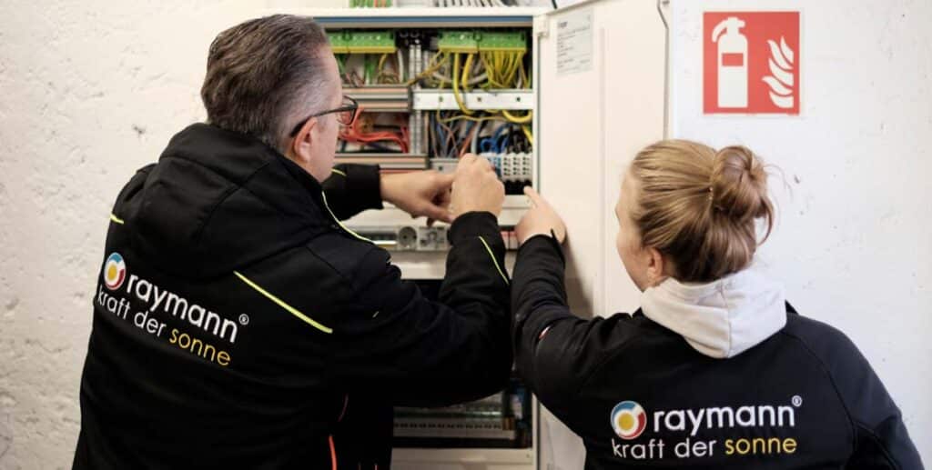 Elektriker arbeiten an einem Schaltkasten